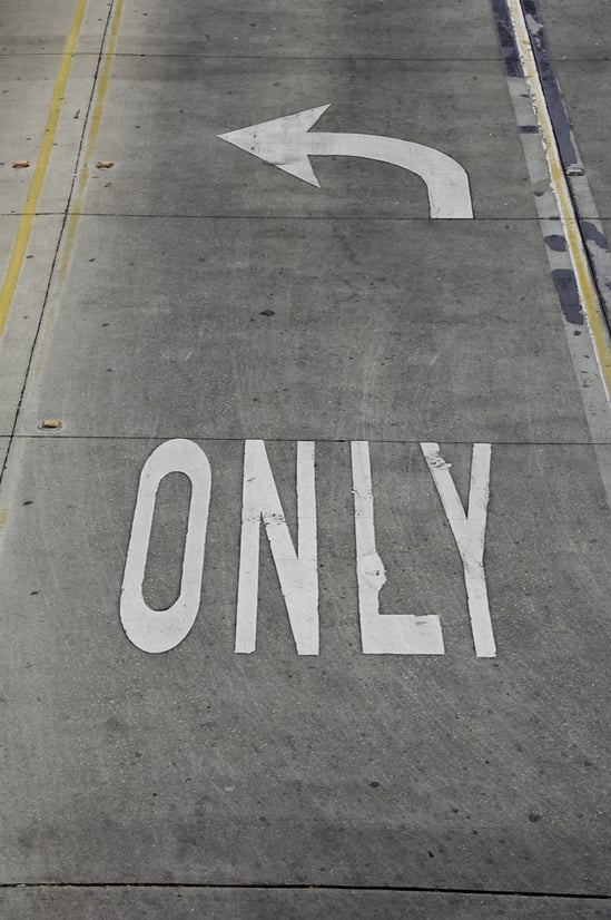 Traffic sign painted white on left-turn lane