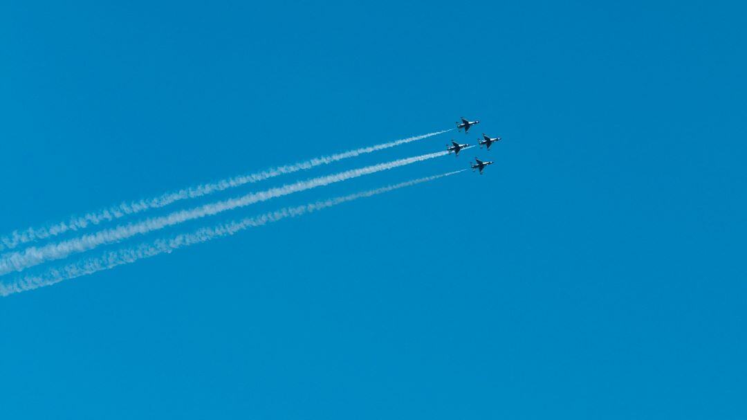 fighter jets in formation on blue sky