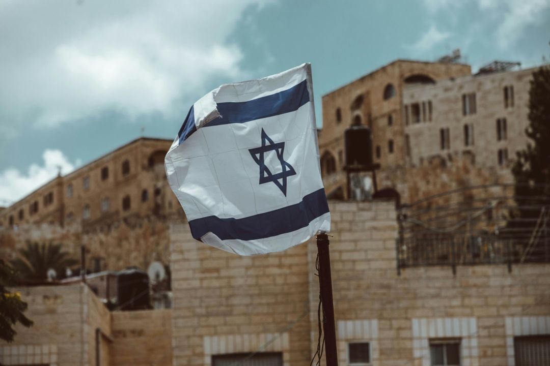 blue and white flag on pole Israel flag