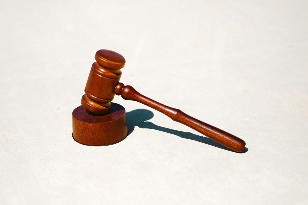 wooden gavel and block on white table